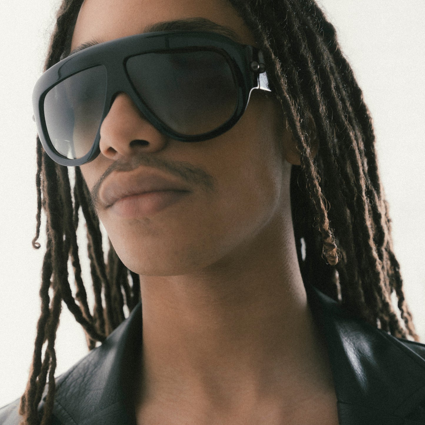 Black oversized aviator sunglasses with bold acetate frame – worn by male model