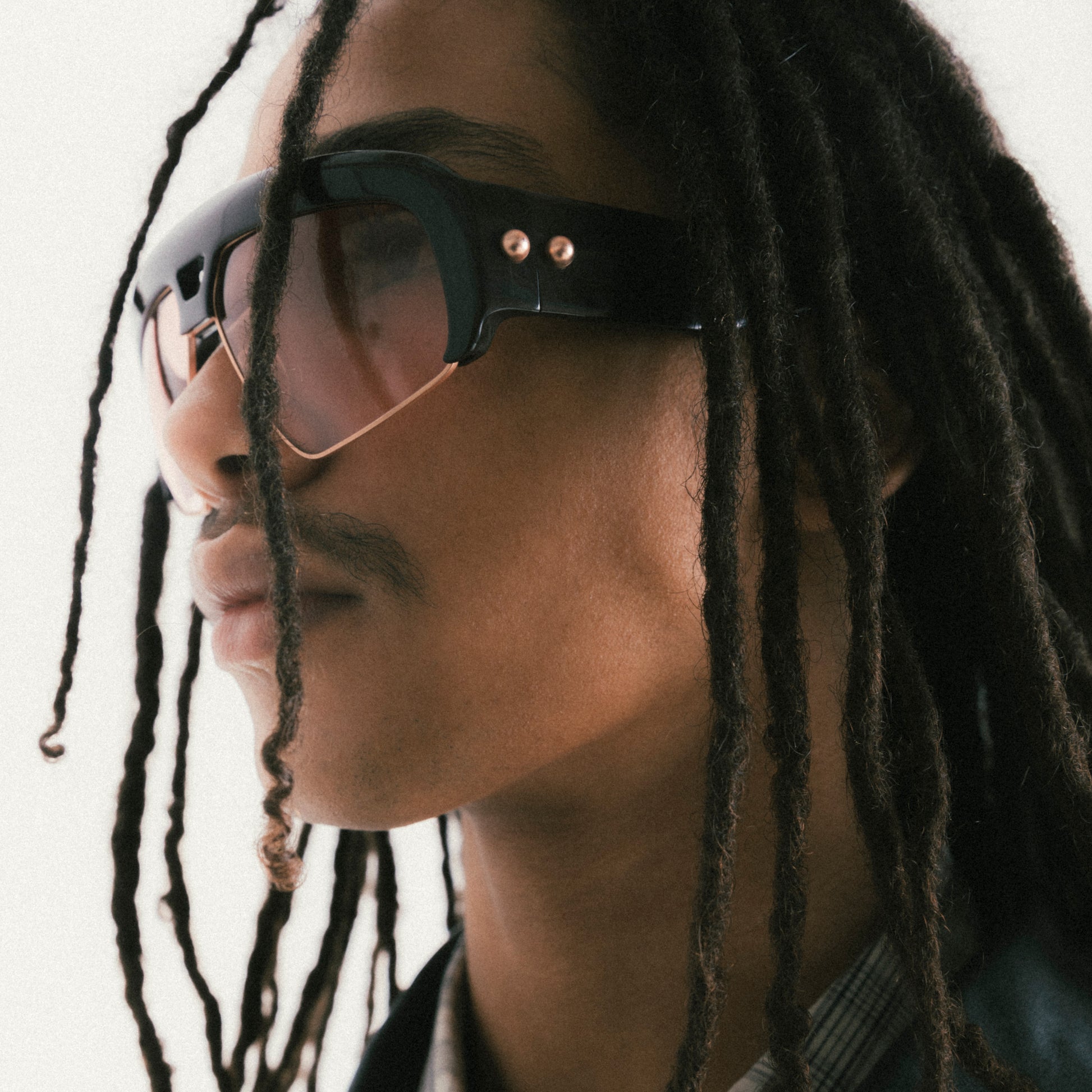 Deep brown oversized aviator sunglasses with acetate and metal frame – male model side view