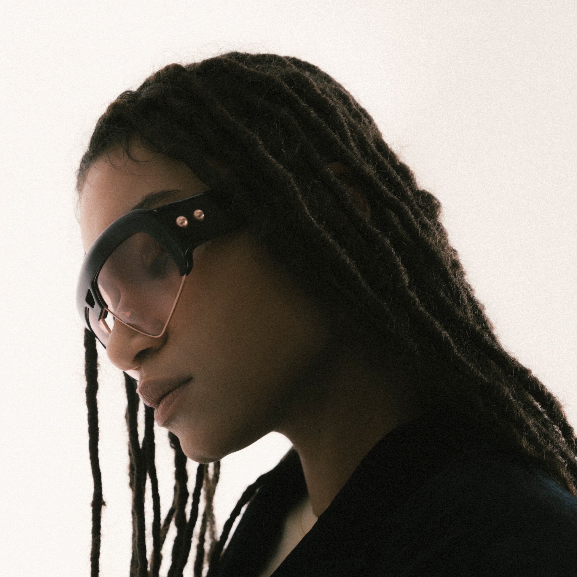 Deep brown oversized aviator sunglasses with acetate and metal frame – female model side view