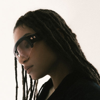 Deep brown oversized aviator sunglasses with acetate and metal frame – female model side view