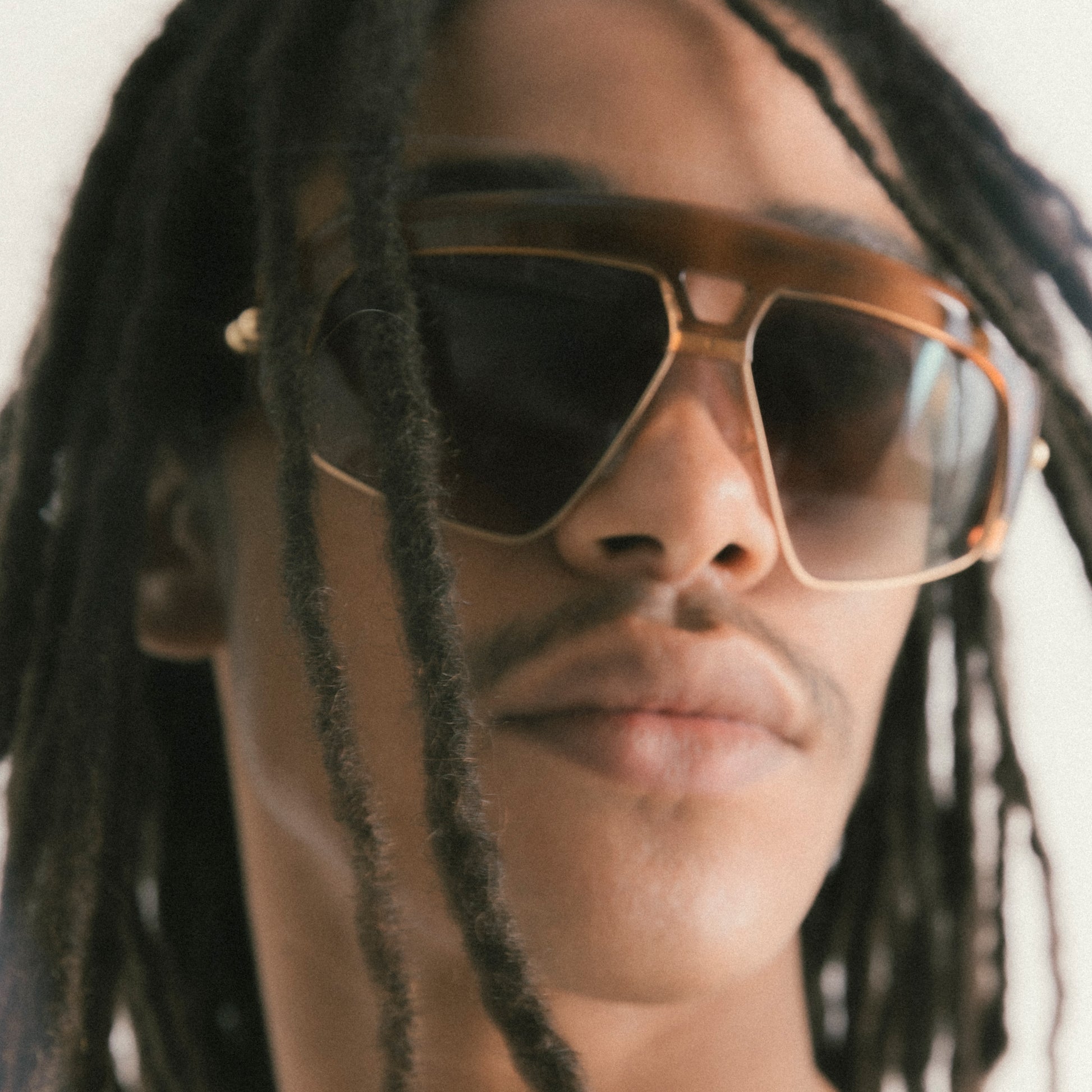 Transparent brown oversized aviator sunglasses with acetate and metal frame – male model front view with slight side angle