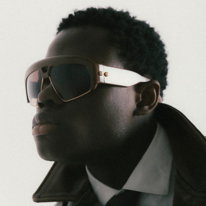 Brown oversized aviator sunglasses with acetate and metal frame – male model view from a soft side angle