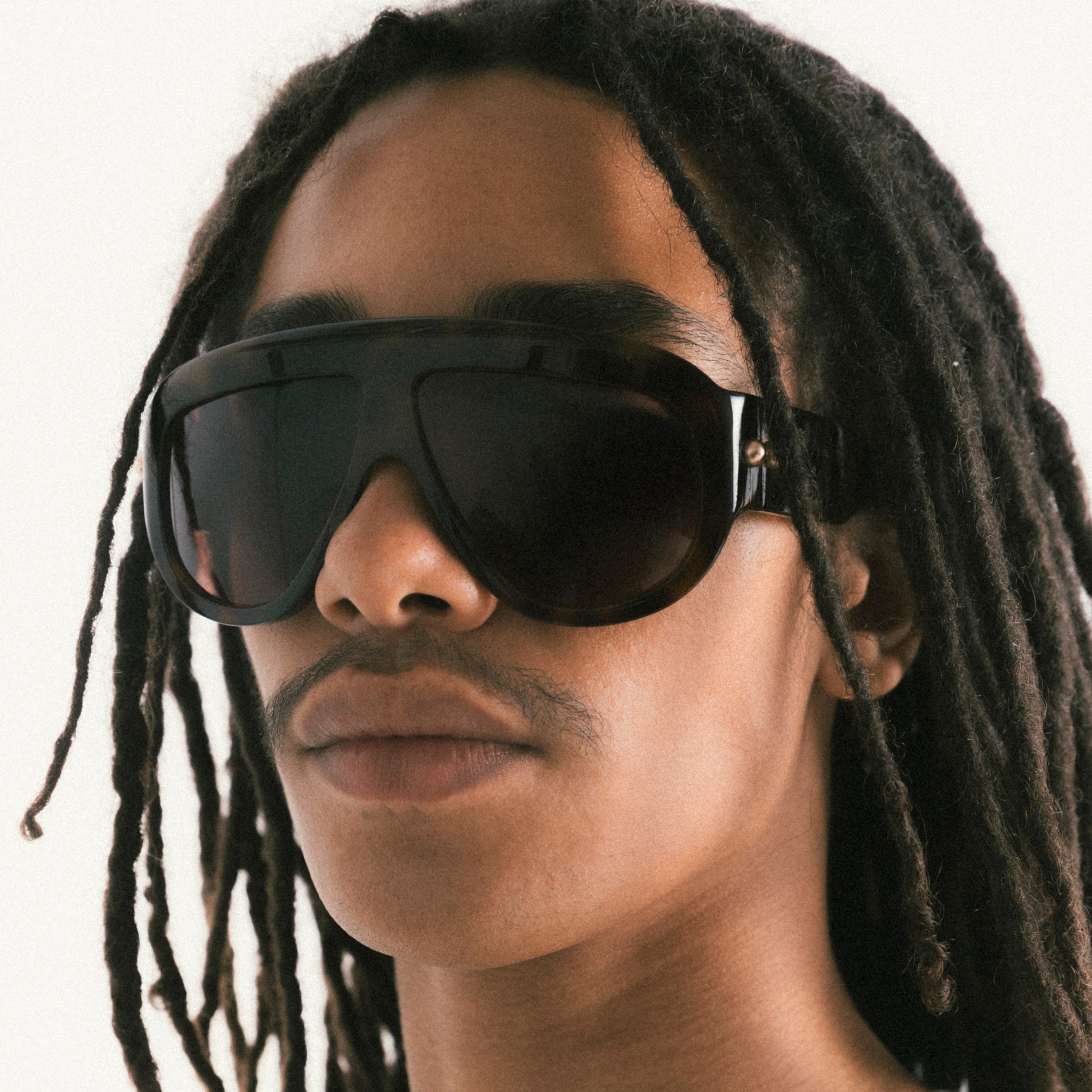 Tortoiseshell oversized aviator sunglasses with bold acetate frame – worn by male model