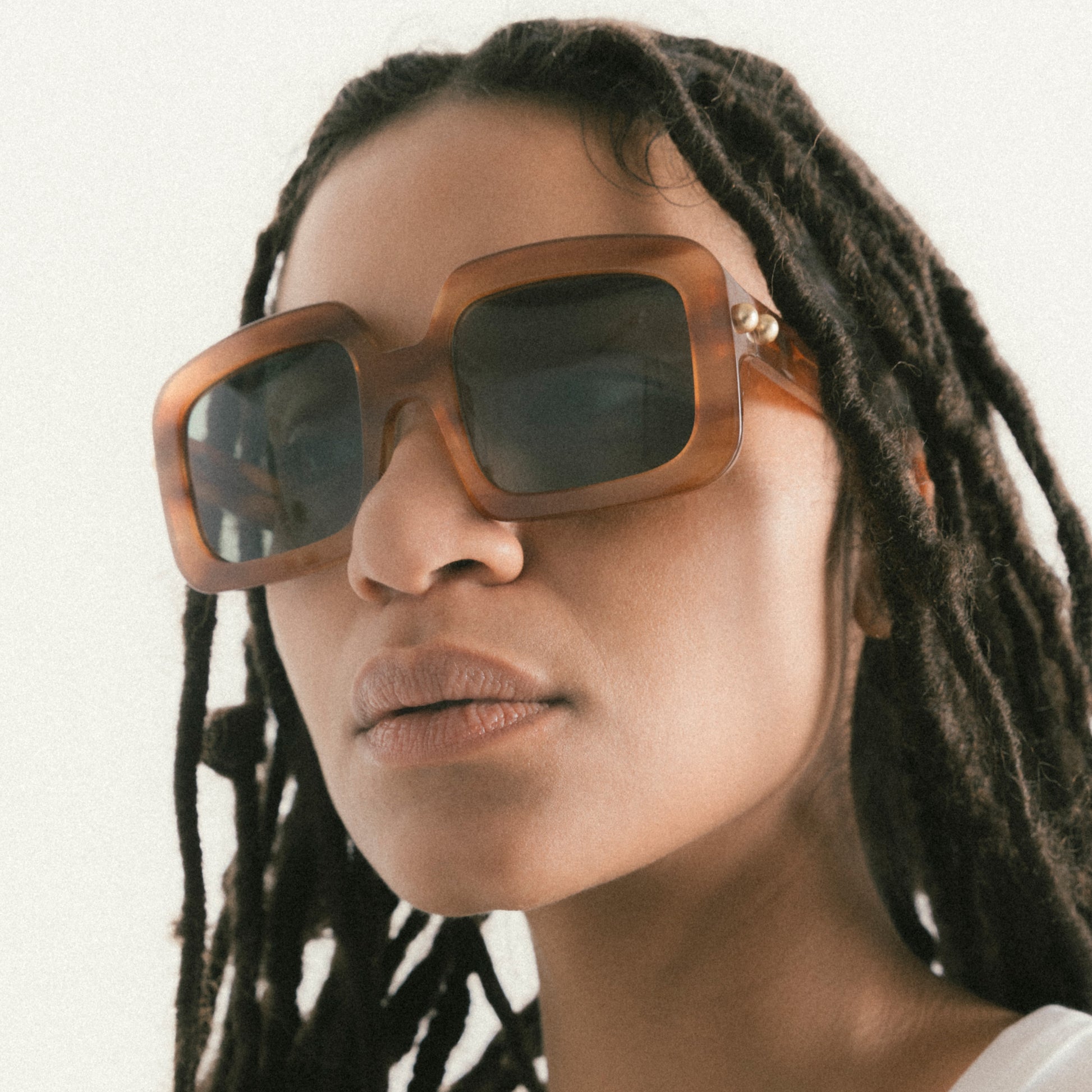 Square brown / striped Havana acetate sunglasses worn by female model – side profile with soft angle