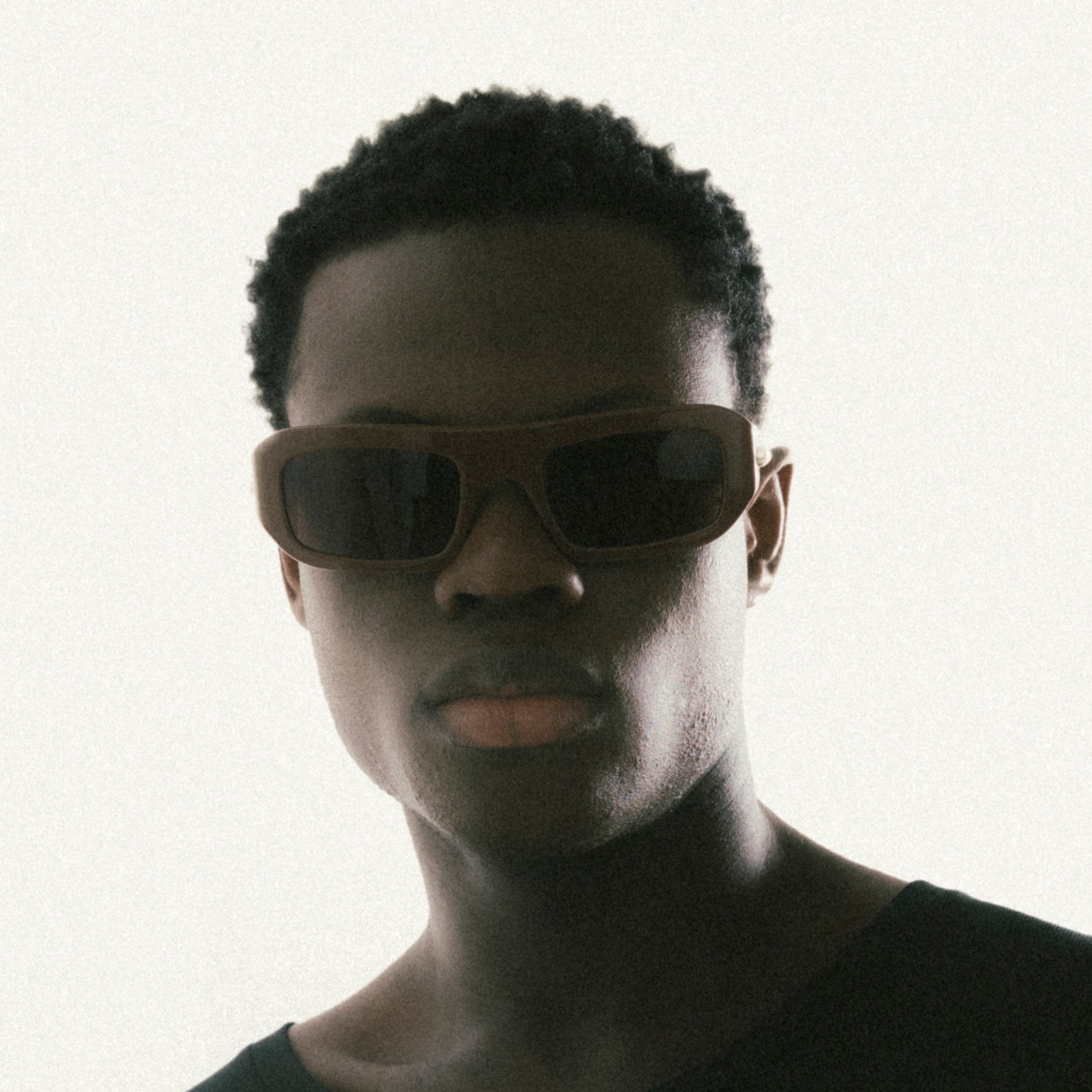 Brown rectangular acetate sunglasses worn by male model – three-quarter profile view studio image
