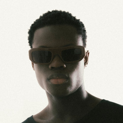 Brown rectangular acetate sunglasses worn by male model – three-quarter profile view studio image