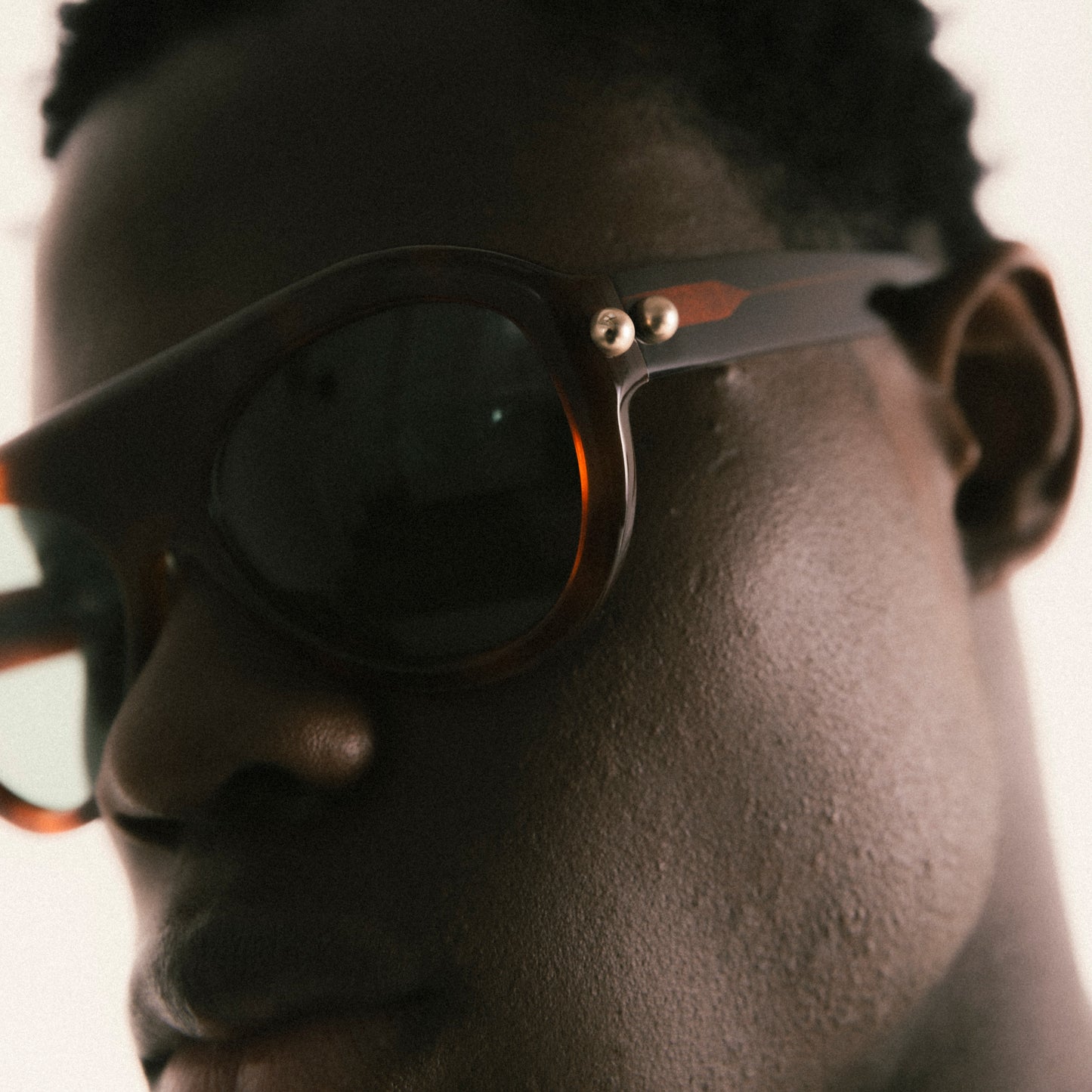 Brown aviator sunglasses in Havana acetate – worn by male model, close-up portrait 