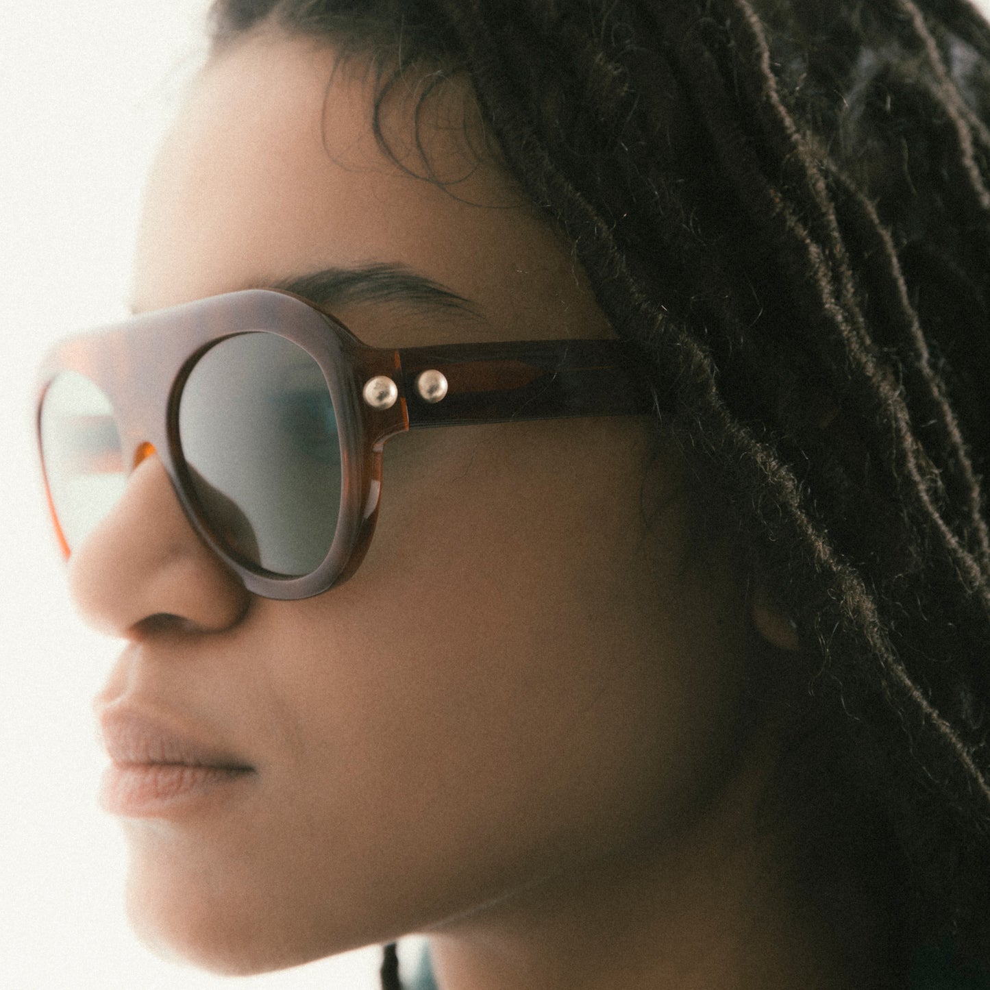 Brown aviator sunglasses in Havana acetate – worn by female model, side angle view